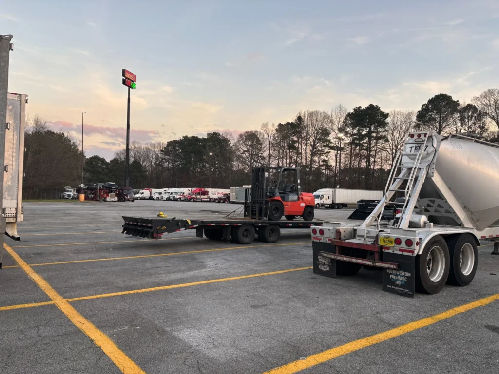 Flatbed trailer and loading area photographed during equipment positioning