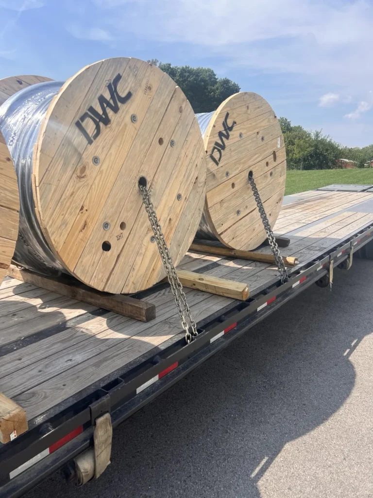 Large cable reels positioned on a flatbed trailer